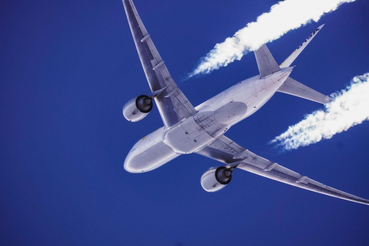 Aircraft flying in dark blue sky